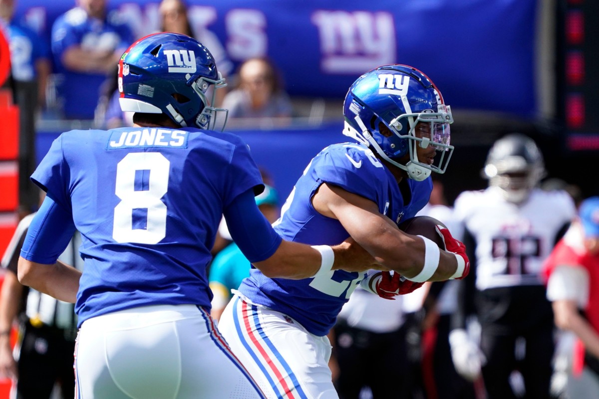 New York Giants quarterback Daniel Jones (8) hands the ball off to running back Saquon Barkley (26) in the first half at MetLife Stadium on Sunday, Sept. 26, 2021, in East Rutherford.