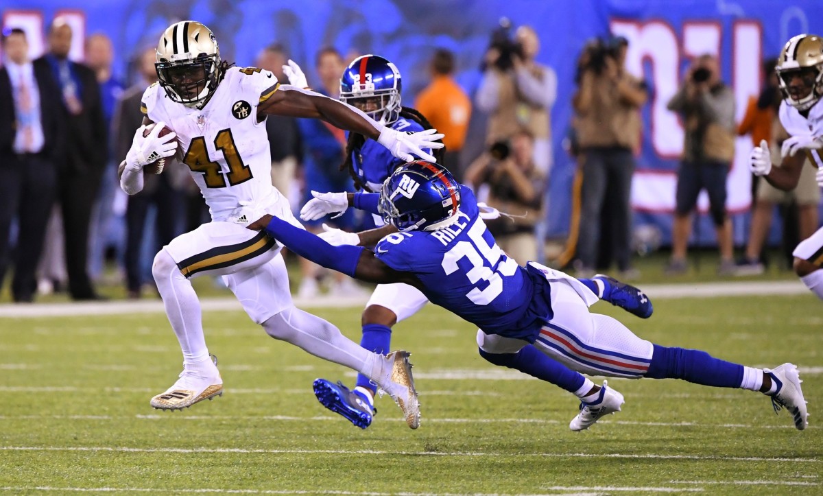 Sep 30, 2018; New Orleans Saints running back Alvin Kamara (41) runs past New York Giants cornerback Curtis Riley (35) for a touchdown during the 4th quarter. Mandatory Credit: Robert Deutsch-USA TODAY Sports