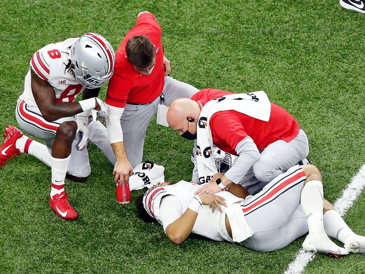 Ohio State's Justin Fields gets treatment after being on the receiving end of targeting