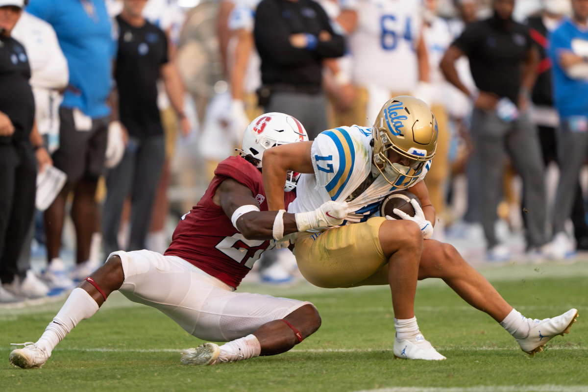 Stanford Cardinal safety Kendall Williamson (21) tackles UCLA Bruins wide receiver Logan Loya (17) during the third quarter at Stanford Stadium.