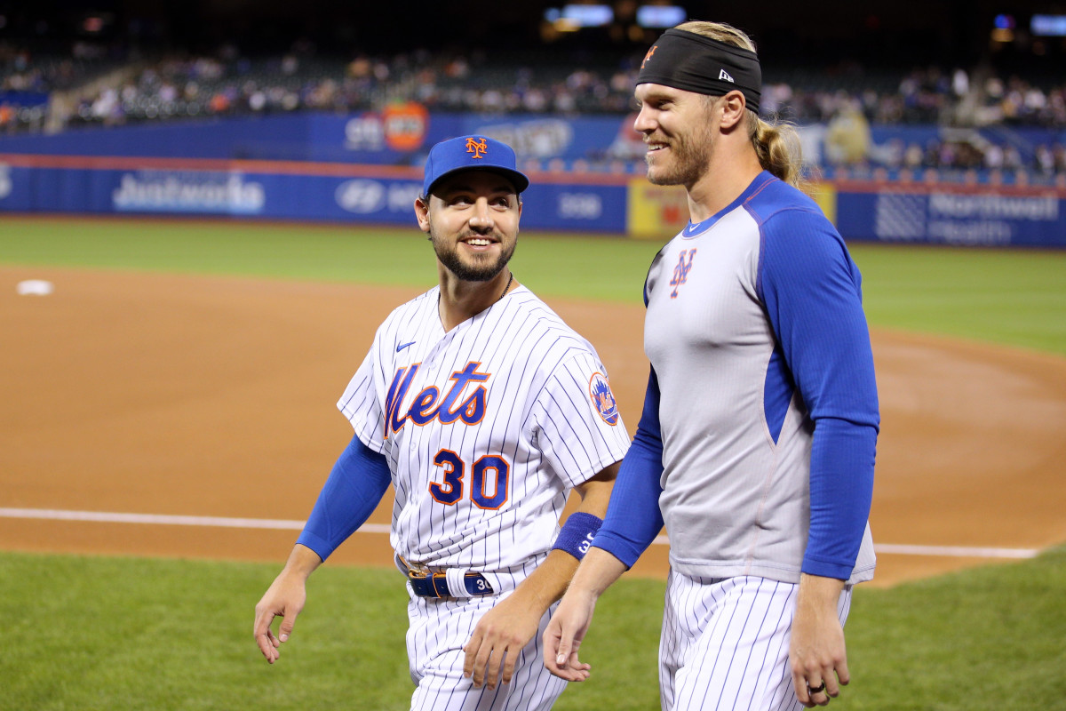 Sep 29, 2021; New York City, New York, USA; New York Mets right fielder Michael Conforto (30) and starting pitcher Noah Syndergaard (34) walk to the dugout before a game against the Miami Marlins at Citi Field.