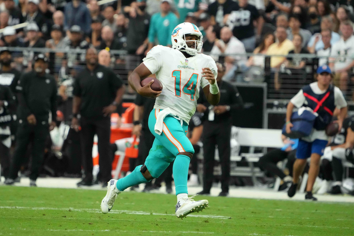Sep 26, 2021; Paradise, Nevada, USA; Miami Dolphins quarterback Jacoby Brissett (14) carries the ball against the Las Vegas Raiders in the second half at Allegiant Stadium.The Raiders defeated the Dolphins 31-28 in overtime. Mandatory Credit: Kirby Lee-USA TODAY Sports