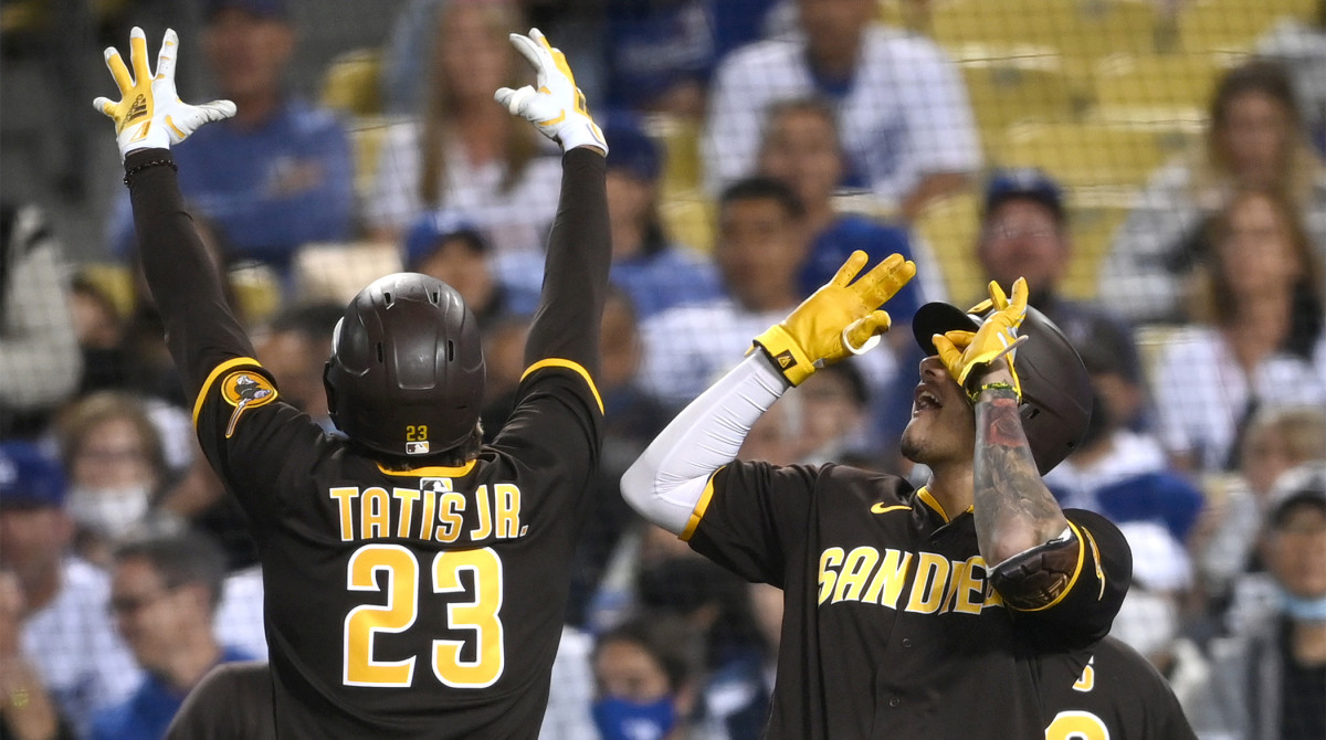 Sep 30, 2021; Los Angeles, California, USA; San Diego Padres shortstop Fernando Tatis Jr. (23) celebrates with San Diego Padres third baseman Manny Machado (13) after hitting a solo home run in the fifth inning of the game against the Los Angeles Dodgers at Dodger Stadium.