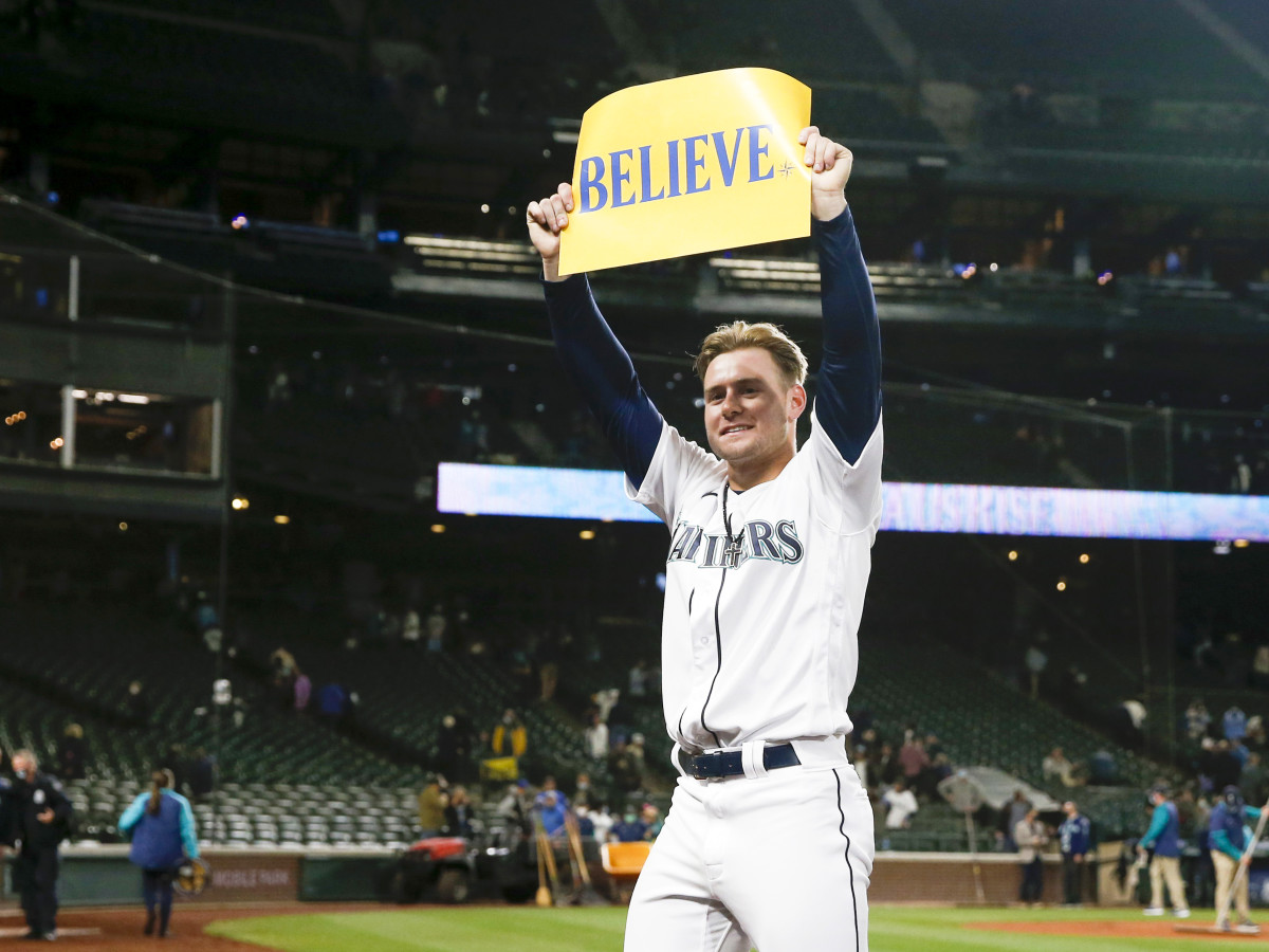 Sep 29, 2021; Seattle, Washington, USA; Seattle Mariners center fielder Jarred Kelenic (10) holds a "BELIEVE" sign following a victory against the Oakland Athletics at T-Mobile Park.