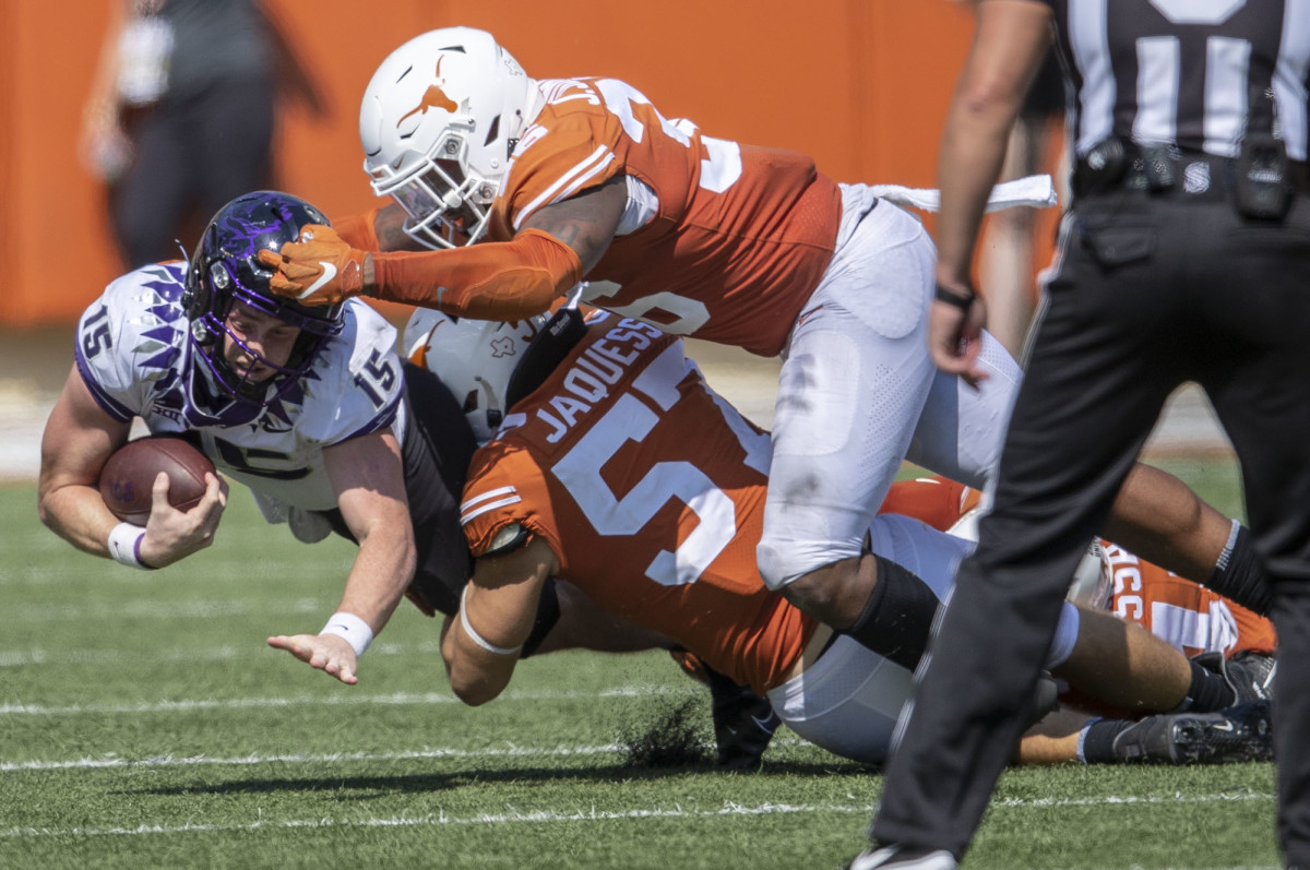 Oct 3, 2020; Austin, TX, USA; TCU Horned Frogs quarterback Max Duggan (15) fights for the first down against Texas Longhorns defensive lineman Jacoby Jones (36) and Texas Longhorns linebacker Cort Jaquess (57) in the 4th quarter in a NCAA college football game at Darrell K Royal-Texas Memorial Stadium.