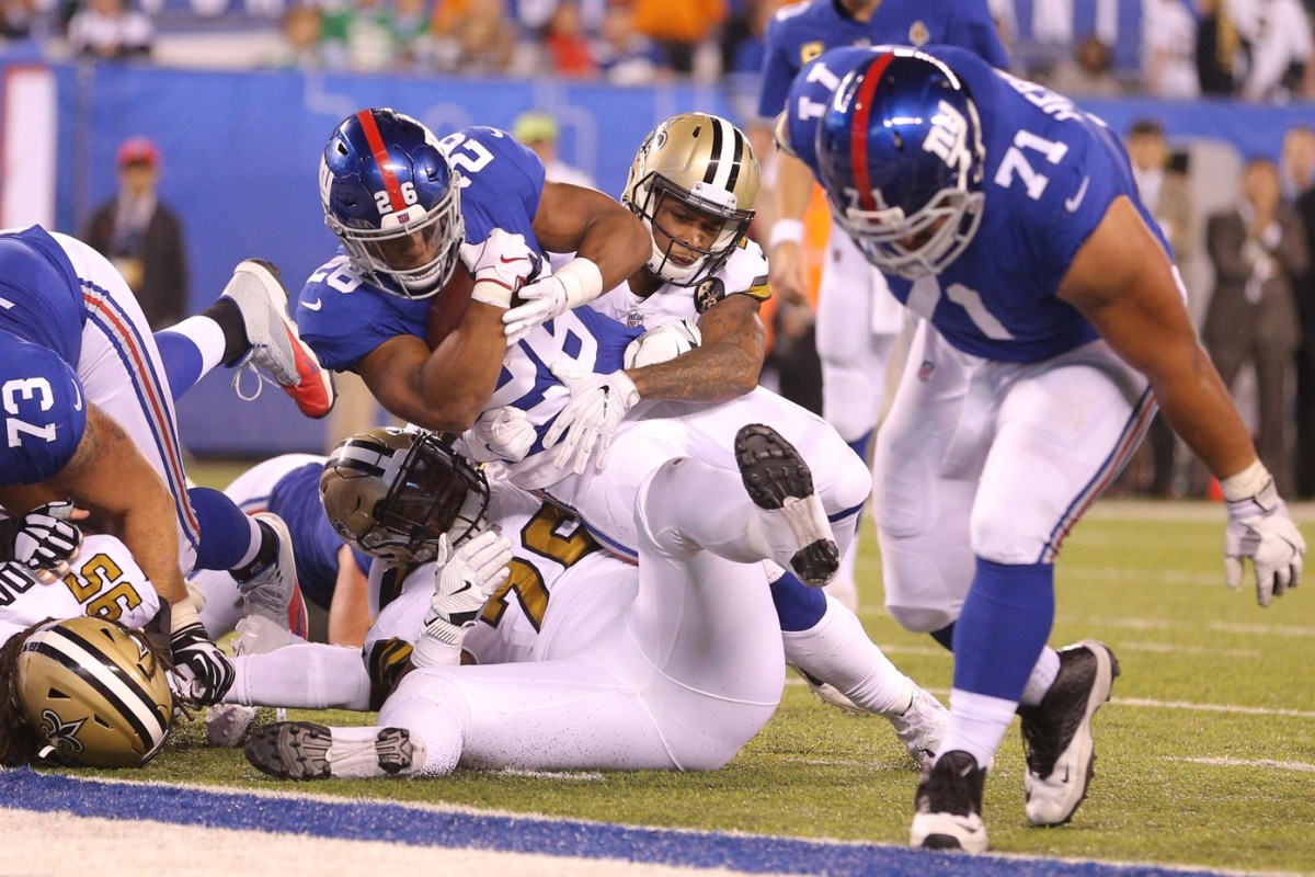 New York Giants running back Saquon Barkley (26) is tackled by the New Orleans Saints defense. Mandatory Credit: Brad Penner-USA TODAY Sports