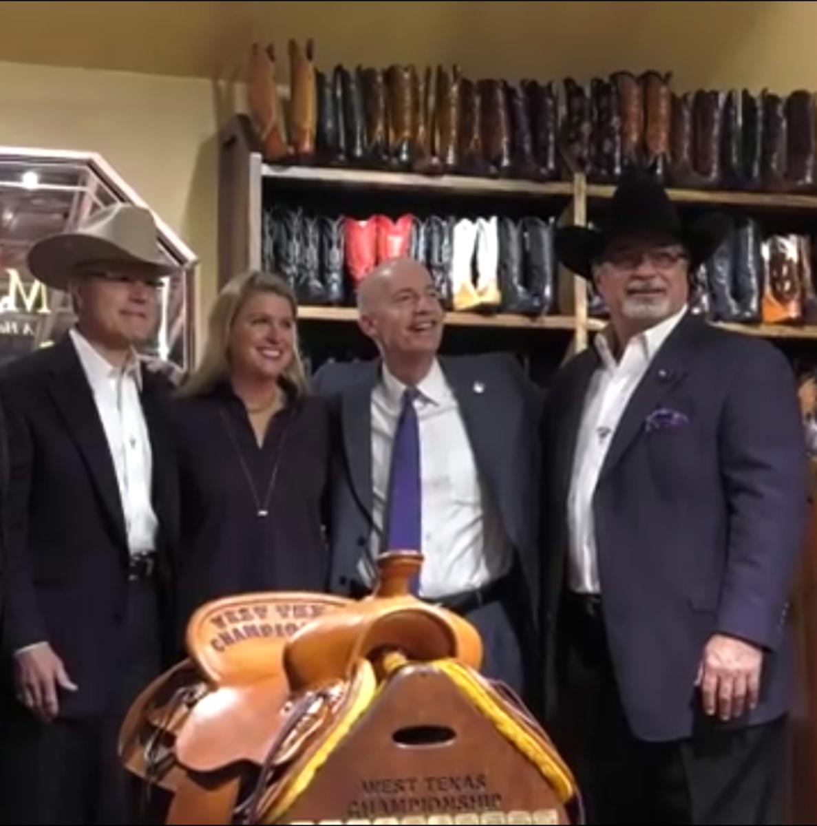 West Texas Championship Saddle donated by ML Leddy's of Fort Worth. Pictured from left to right: Wilson and Martha Franklin, TCU Chancellor Victor Boschini, and Mark Dunlap