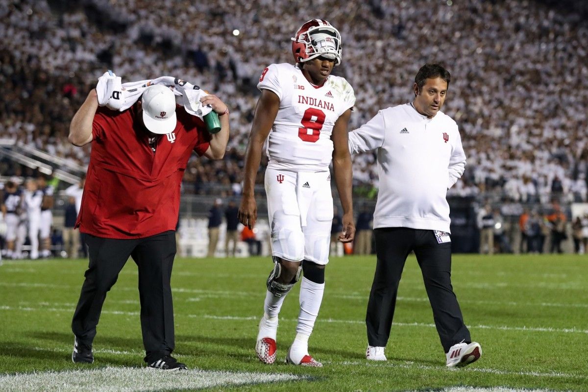 Indiana quarterback Michael Penix Jr. is helped off the field after injuring his throwing shoulder in the third quarter against Penn State. (USA TODAY Sports)