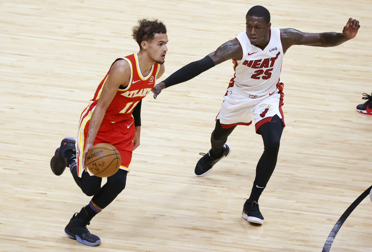 Atlanta Hawks guard Trae Young (11) brings the ball up court around Miami Heat guard Kendrick Nunn (25) during the first half at American Airlines Arena.