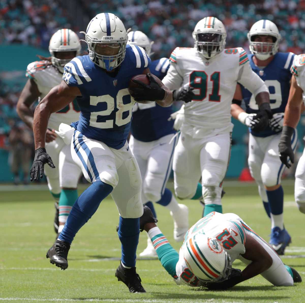 Running back Jonathan Taylor sheds a defender as he runs in for a touchdown at Hard Rock Stadium in Miami Gardens, Fla., on Sunday, Oct. 3, 2021, during first half Miami vs. Indianapolis action. 100321 Coltsmiami 019 Jw