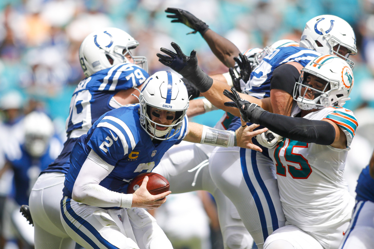 Oct 3, 2021; Miami Gardens, Florida, USA; Indianapolis Colts quarterback Carson Wentz (2) runs out of the pocket as Miami Dolphins linebacker Jaelan Phillips (15) attempts a sack during the second quarter of the game at Hard Rock Stadium.