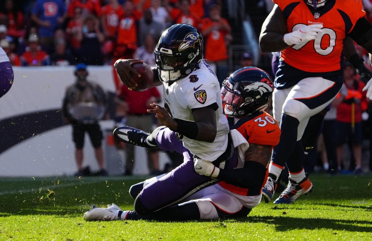 Denver Broncos safety Caden Sterns (30) sacks Baltimore Ravens quarterback Lamar Jackson (8) in the third quarter at Empower Field at Mile High.