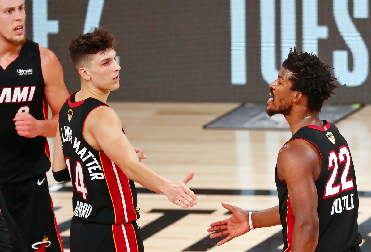 Miami Heat forward Jimmy Butler (22) reacts after a play against the Los Angeles Lakers as he high fives guard Tyler Herro (14) during the fourth quarter of game three of the 2020 NBA Finals at AdventHealth Arena.