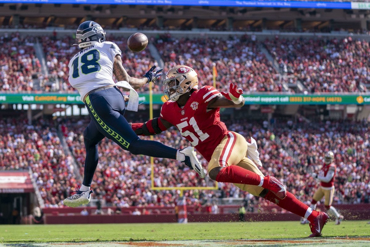 Seattle Seahawks wide receiver Freddie Swain (18) catches a touchdown pass against San Francisco 49ers linebacker Azeez Al-Shaair (51) during the third quarter at Levi's Stadium.