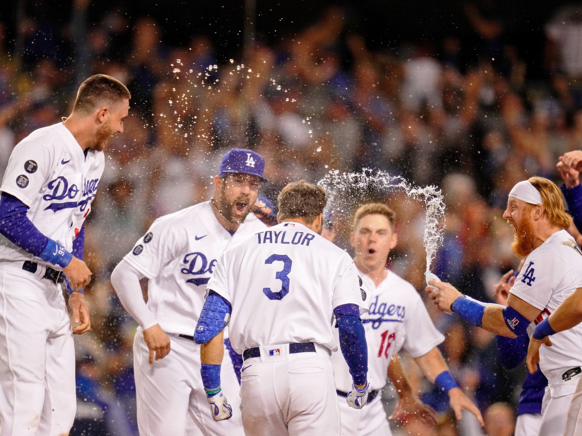 Oct 6, 2021; Los Angeles, California, USA; The Los Angeles Dodgers celebrate the walk-off two run home run hit by left fielder Chris Taylor (3) against the St. Louis Cardinals during the ninth inning at Dodger Stadium. The Los Angeles Dodgers won 3-1.