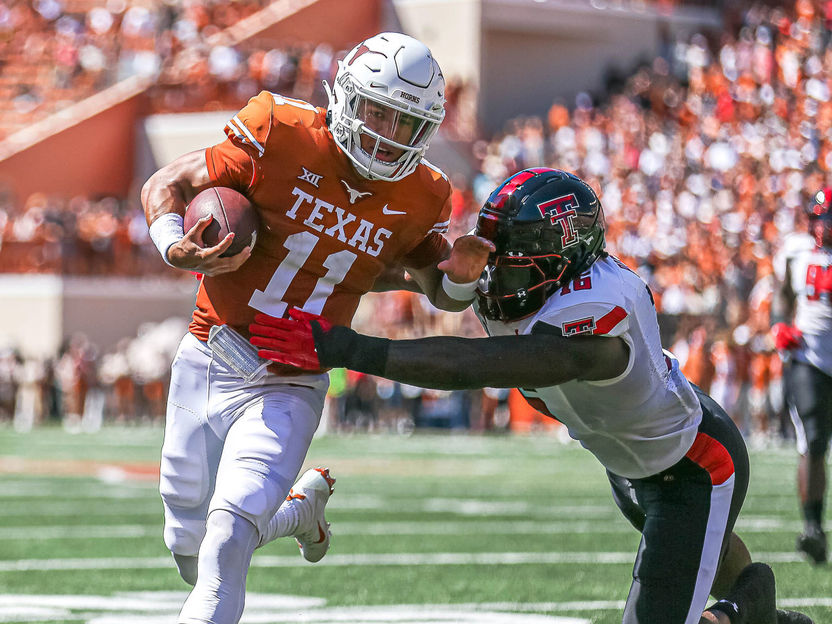 Texas QB Casey Thompson tries to elude a defender's tackle