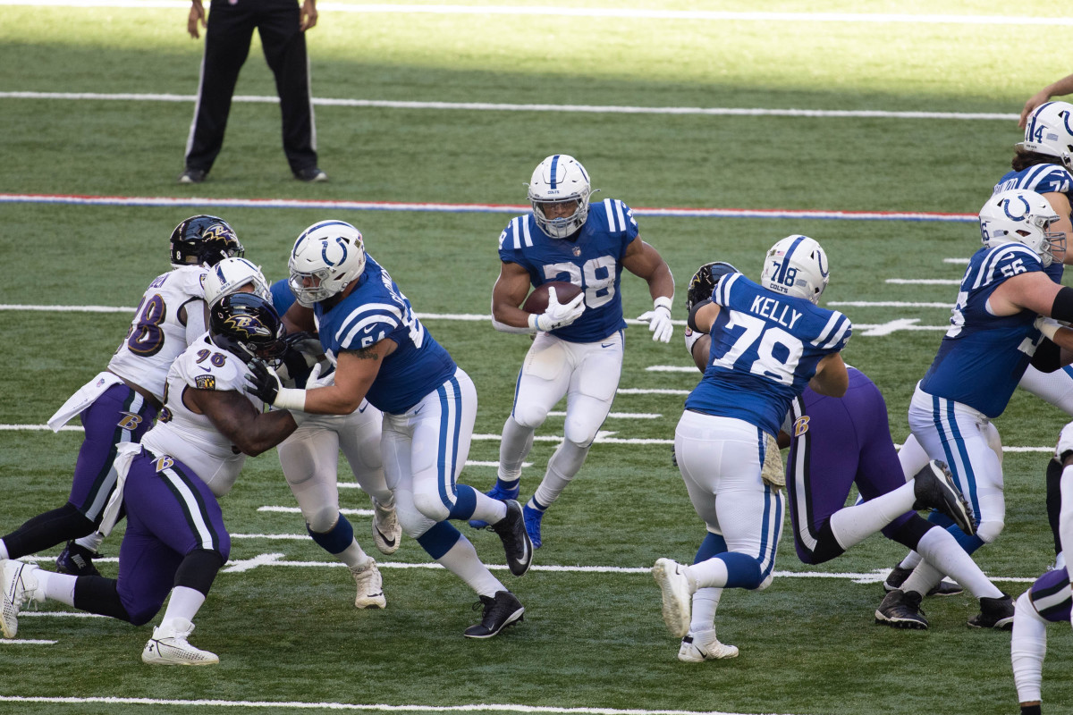 Nov 8, 2020; Indianapolis, Indiana, USA; Indianapolis Colts running back Jonathan Taylor (28) runs the ball against the Baltimore Ravens in the first half at Lucas Oil Stadium.