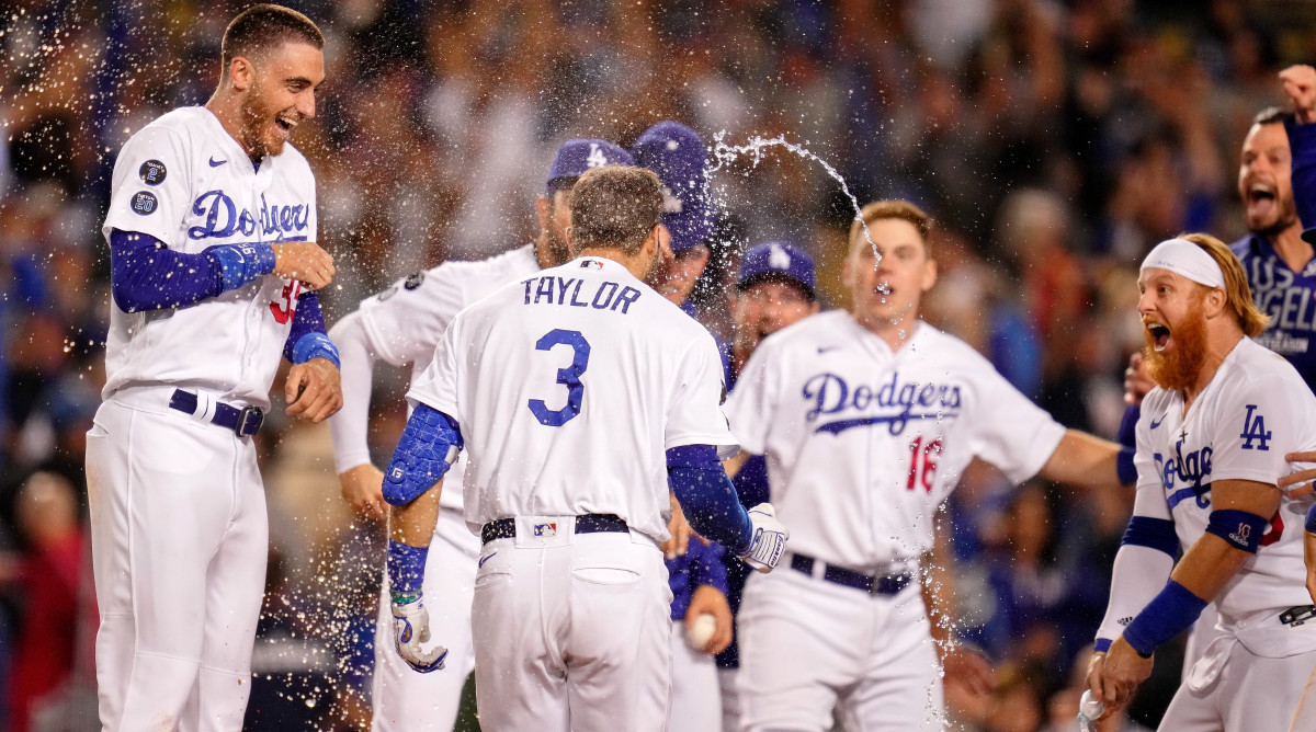 Oct 6, 2021; Los Angeles, California, USA; The Los Angeles Dodgers celebrate the walk-off two run home run hit by left fielder Chris Taylor (3) against the St. Louis Cardinals during the ninth inning at Dodger Stadium. The Los Angeles Dodgers won 3-1.