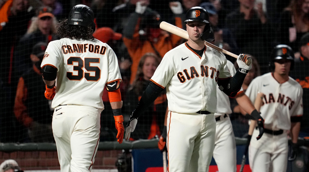 Oct 8, 2021; San Francisco, California, USA; San Francisco Giants shortstop Brandon Crawford (35) celebrates with catcher Buster Posey (28) after hitting a home run in the eighth inning against the Los Angeles Dodgers during game one of the 2021 NLDS at Oracle Park.