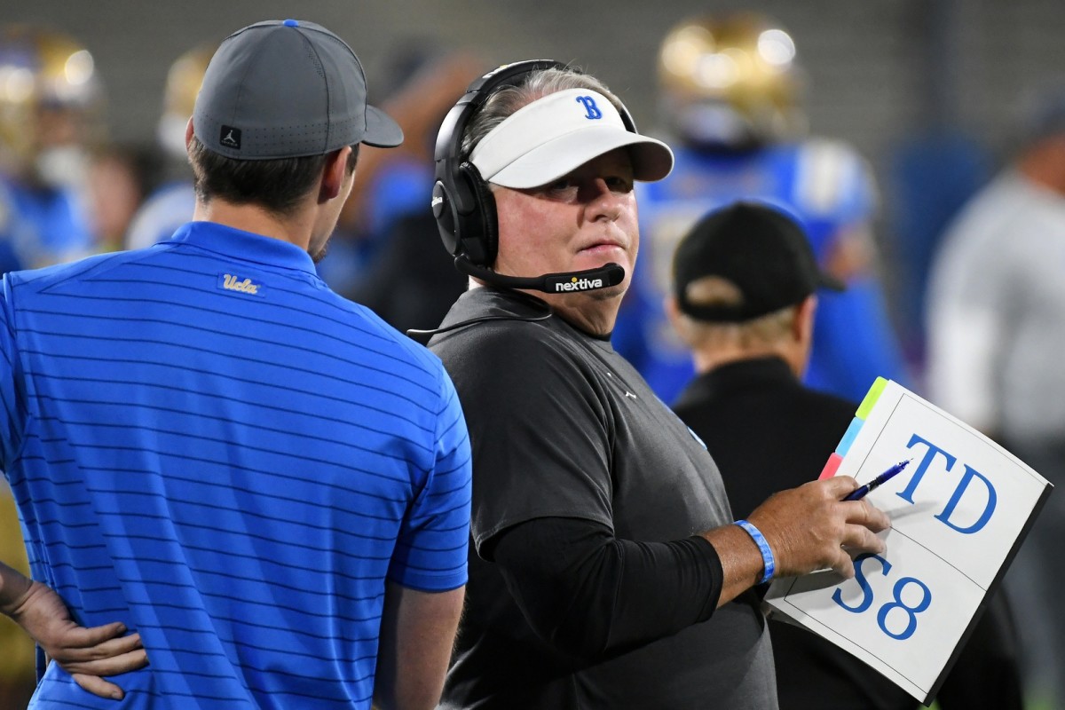 Chip Kelly confers on the UCLA sideline.
