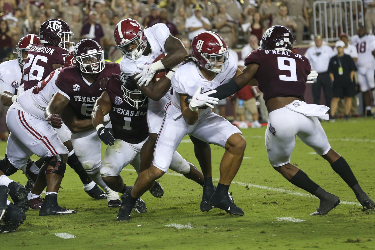 Oct 9, 2021; College Station, Texas, USA;Alabama Crimson Tide running back Brian Robinson Jr (4) is tackled by Texas A&M Aggies linebacker Aaron Hansford (1) in the first quarter at Kyle Field.