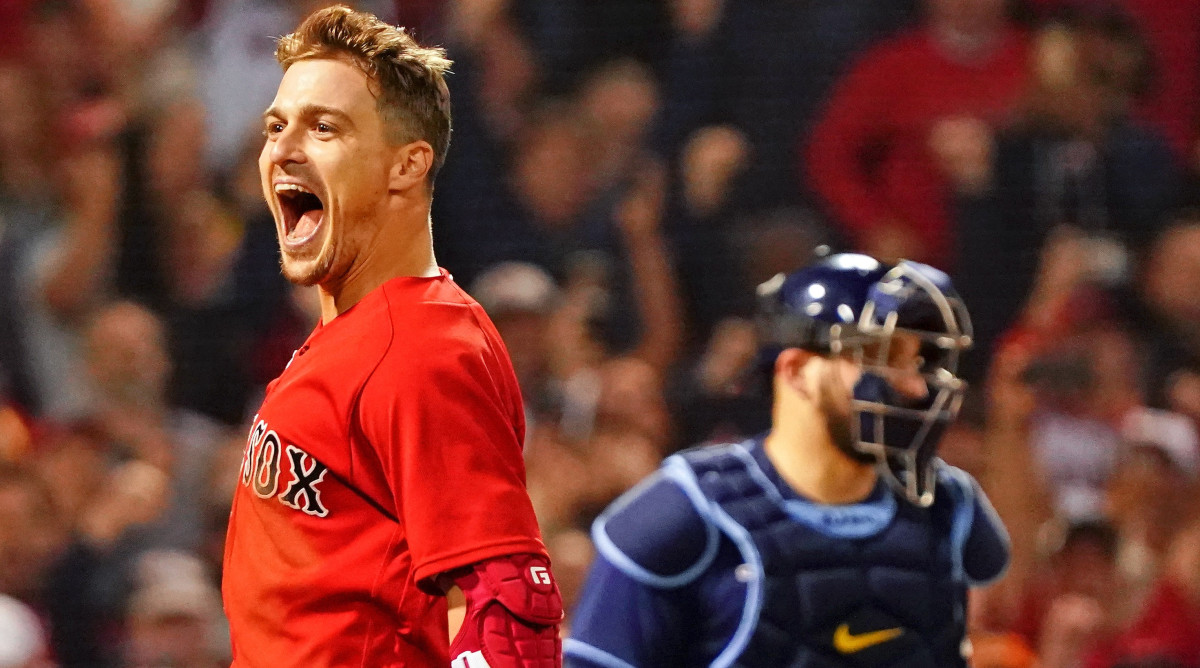 Boston Red Sox center fielder Enrique Hernandez (5) reacts after hitting a walk-off sacrifice fly against the Tampa Bay Rays to score pinch runner Danny Santana (22) during the ninth inning