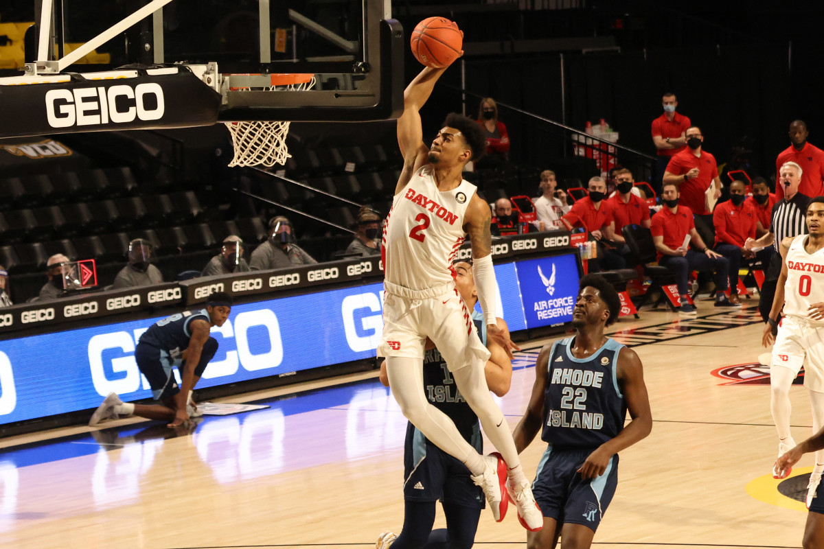 Dayton Flyers guard Ibi Watson (2) dunks the ball as Rhode Island Rams center Makhel Mitchell (22) looks on in the first half in the second round of the 2021 Atlantic 10 Conference Tournament at Stuart C. Siegel Center.
