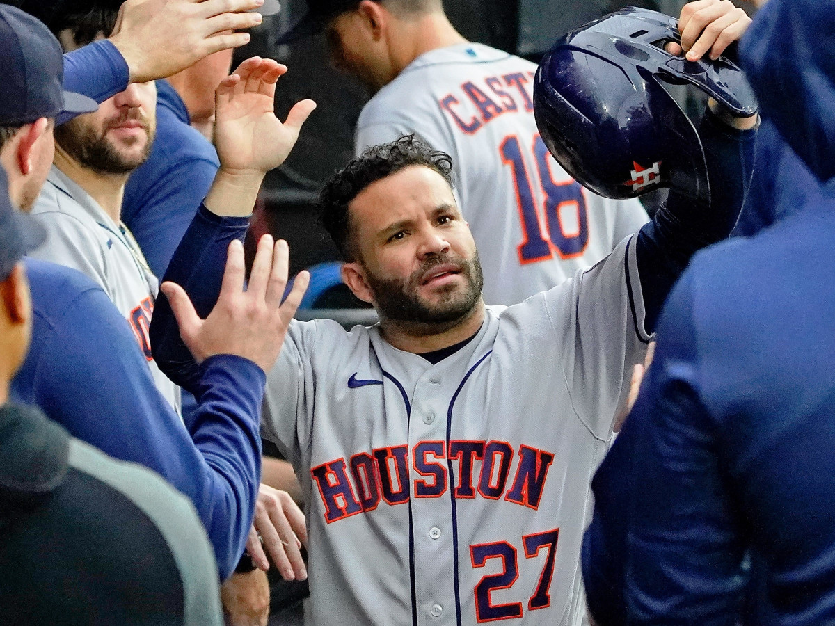 Houston Astros right fielder Kyle Tucker (30) congratulates second baseman Jose Altuve (27) after he scored on a two-run RBI double