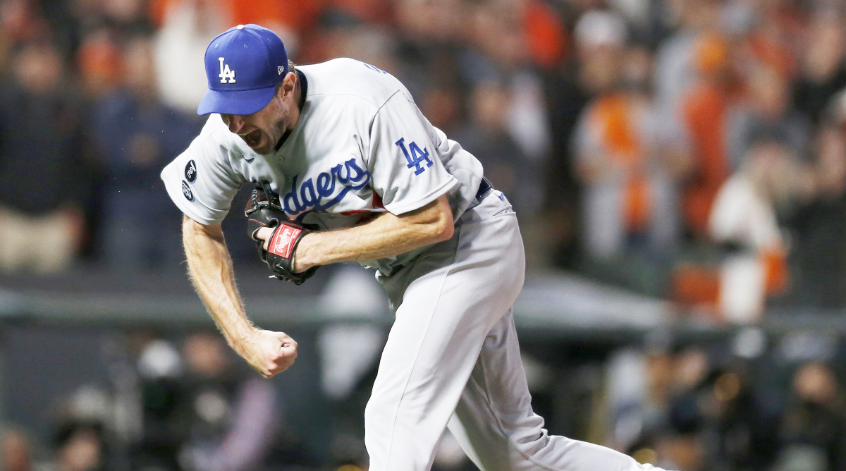 Oct 14, 2021; San Francisco, California, USA; Los Angeles Dodgers pitcher Max Scherzer (31) celebrates recording the final out against the San Francisco Giants in the ninth inning during game five of the 2021 NLDS at Oracle Park.