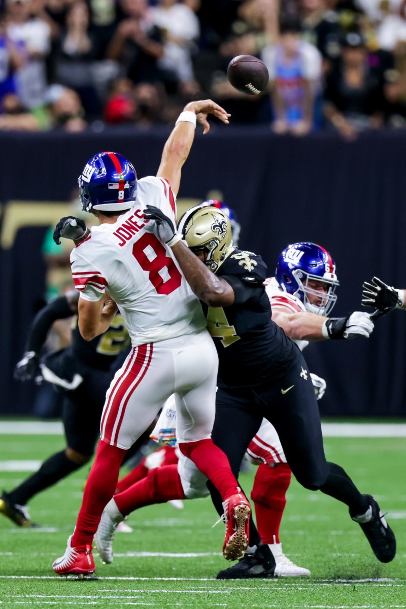 Giants quarterback Daniel Jones (8) throws as he is hit by New Orleans Saints defensive end Cameron Jordan (94). Mandatory Credit: Stephen Lew-USA TODAY Sports