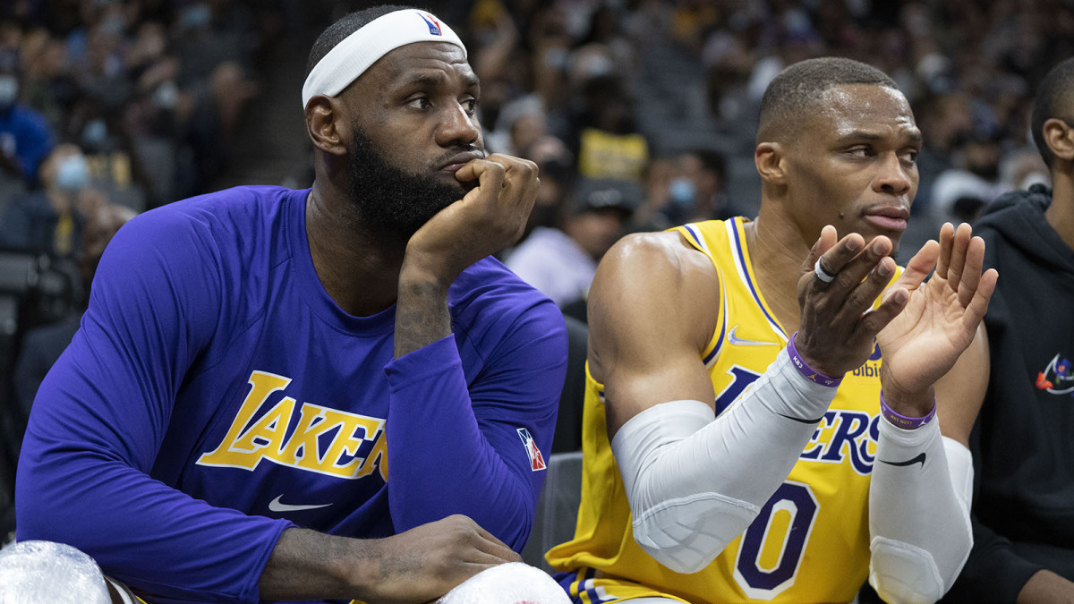 Los Angeles Lakers forward LeBron James (6, left) and guard Russell Westbrook (0) sit on the bench during the fourth quarter.