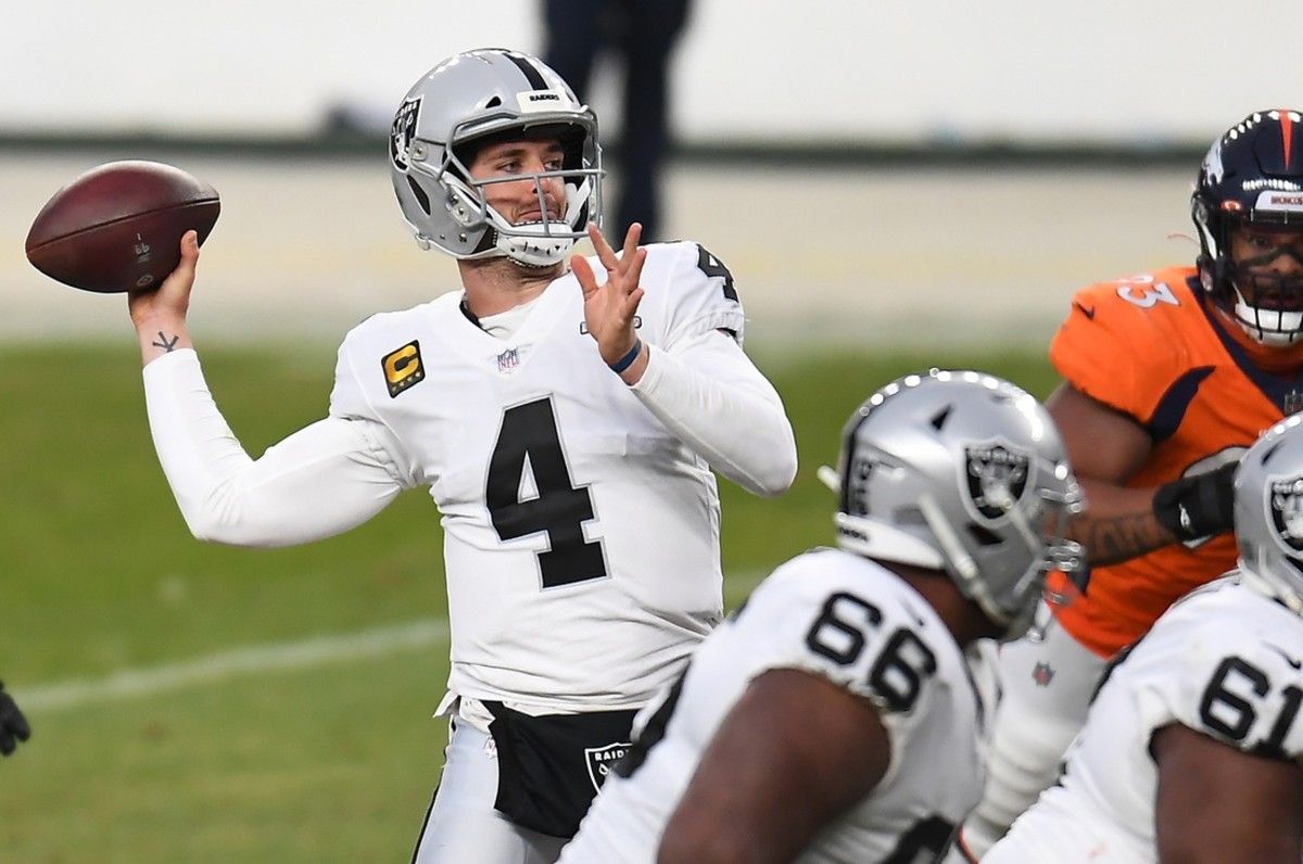 Las Vegas Raiders quarterback Derek Carr (4) throws a pass against the Denver Broncos during the second quarter at Empower Field at Mile High.