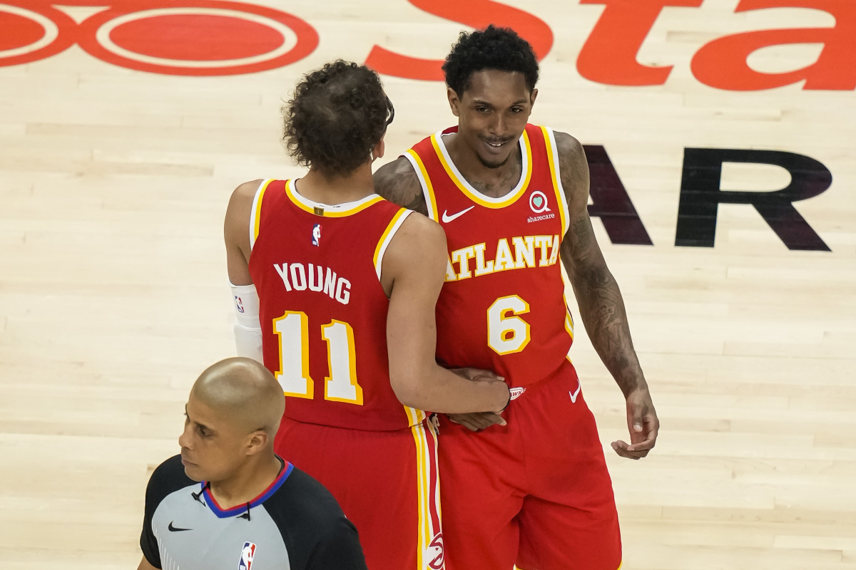 Atlanta Hawks guard Trae Young (11) and guard Lou Williams (6) react after a play against the Orlando Magic during the second half at State Farm Arena.