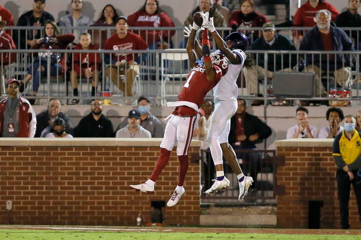 TCU's Quentin Johnston (1) catches a touchdown pass over Oklahoma's Joshua Eaton (1) during a college football game between the University of Oklahoma Sooners (OU) and the TCU Horned Frogs at Gaylord Family-Oklahoma Memorial Stadium in Norman, Okla., Saturday, Oct. 16, 2021. Oklahoma won 52-31.