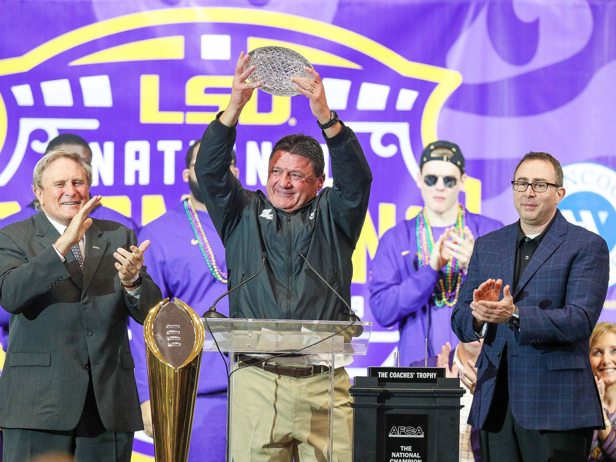 Ed Orgeron lifts the American Football Coaches Association Coaches Trophy in January 2020