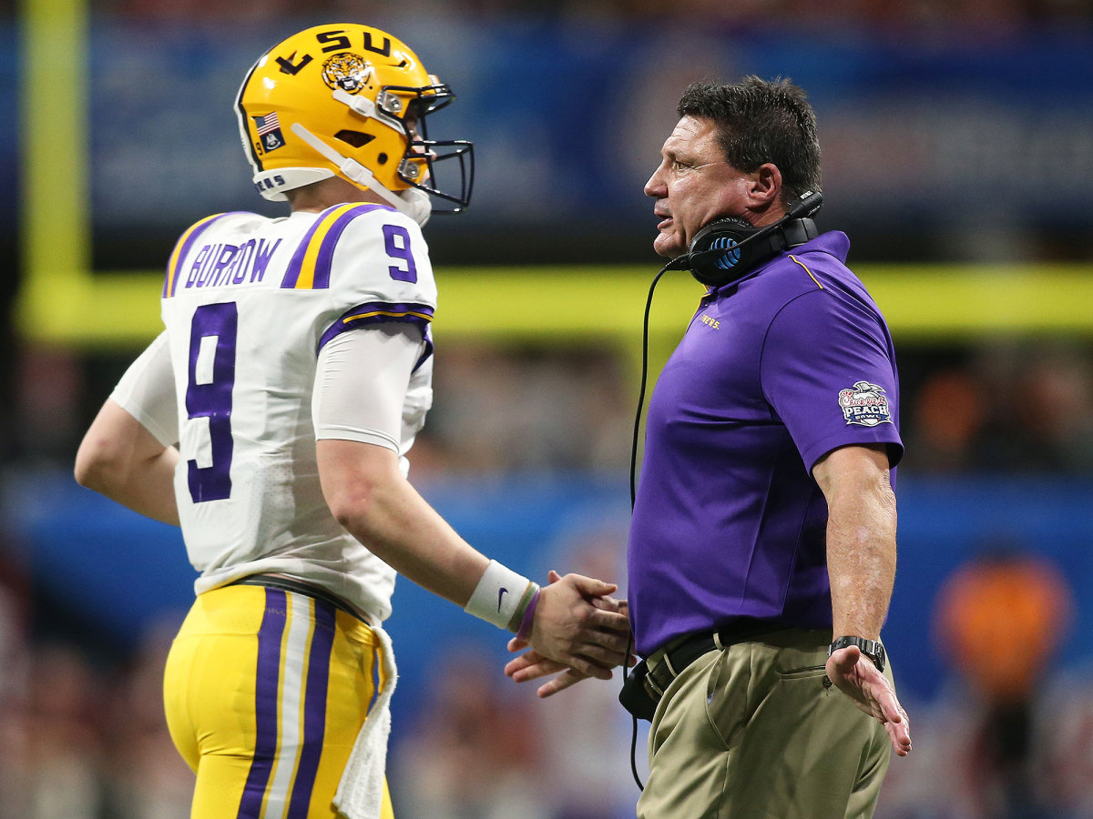 QB Joe Burrow slaps hands with coach Ed Orgeron in 2019