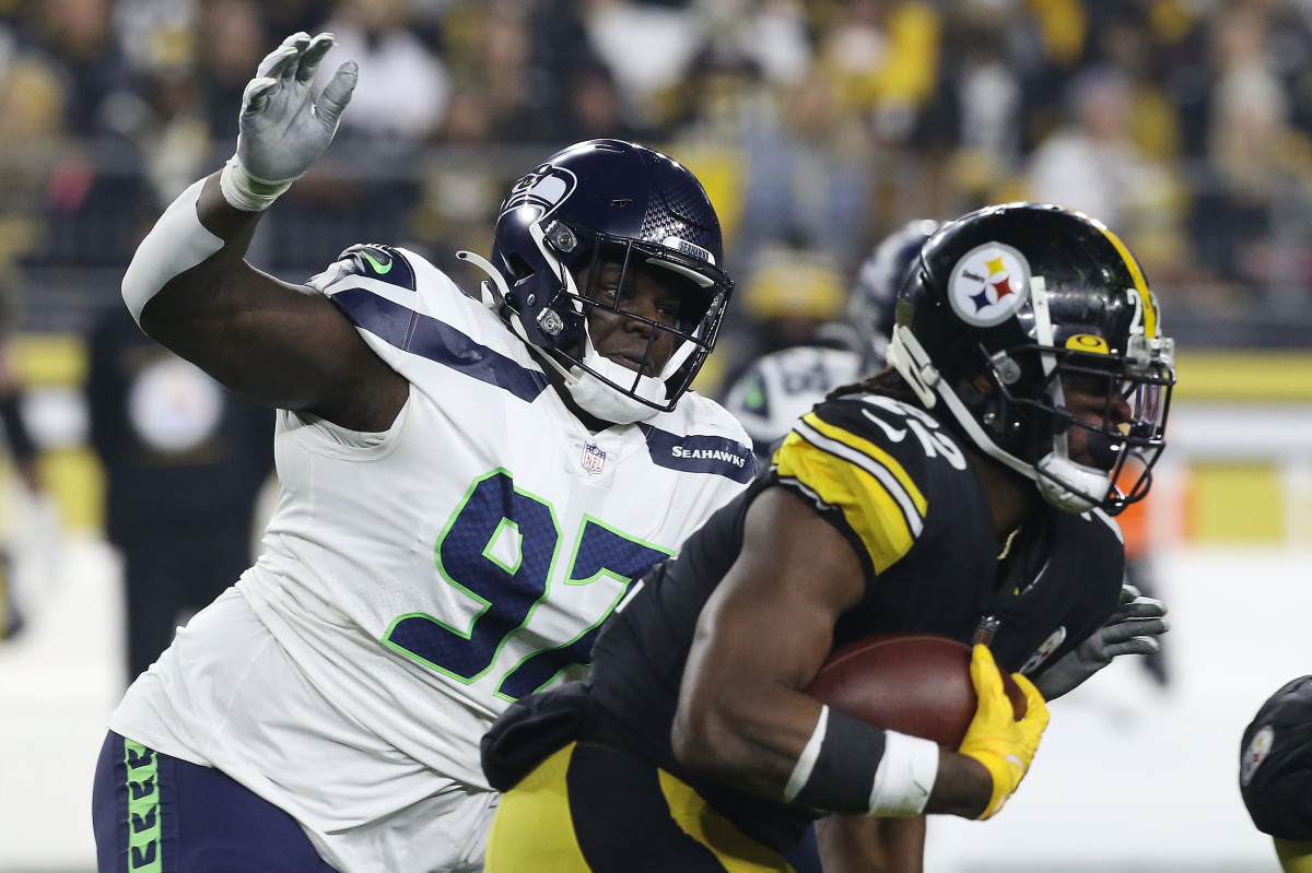 Seattle Seahawks defensive tackle Poona Ford (97) chases Pittsburgh Steelers running back Najee Harris (22) during the first quarter at Heinz Field.