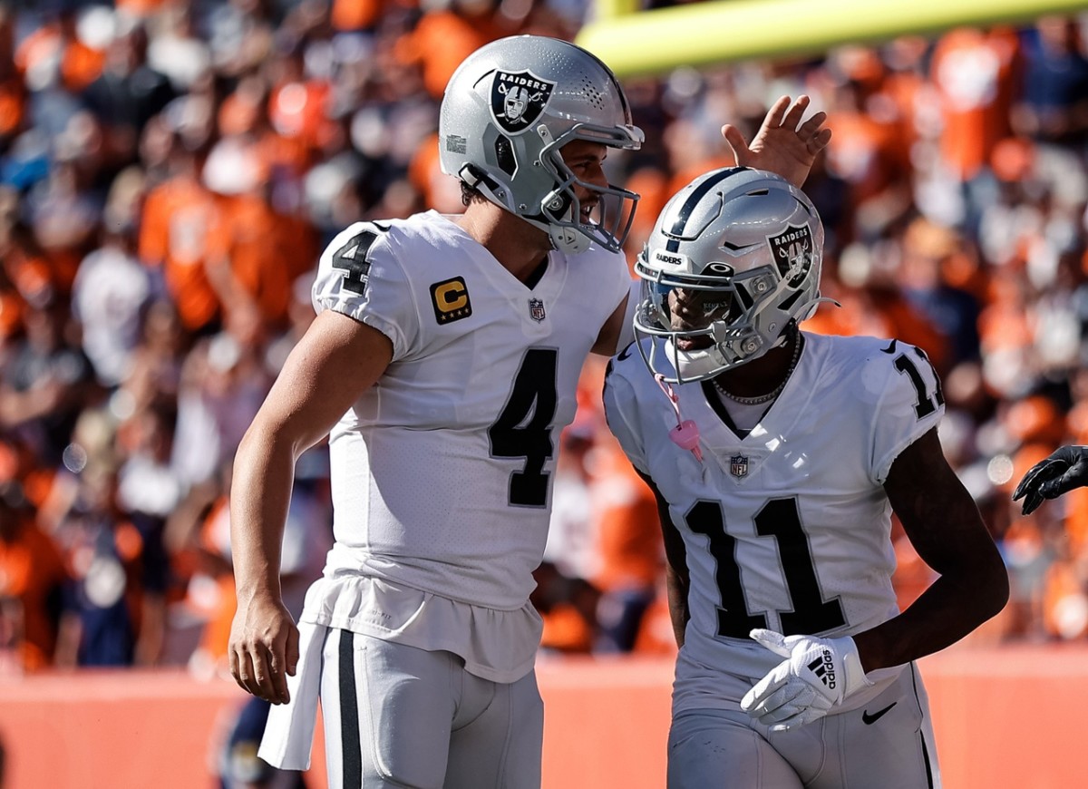 Las Vegas Raiders wide receiver Henry Ruggs III (11) celebrates with quarterback Derek Carr (4) after a touchdown in the first quarter against the Denver Broncos at Empower Field at Mile High.