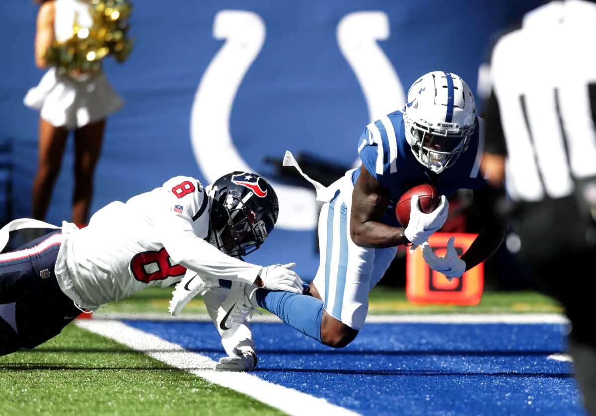 Houston Texans defensive back Terrence Brooks (8) trups up Indianapolis Colts wide receiver Parris Campbell (1) as he carries the ball into the end zone Sunday, Oct. 17, 2021, during a game against the Houston Texans at Lucas Oil Stadium in Indianapolis.