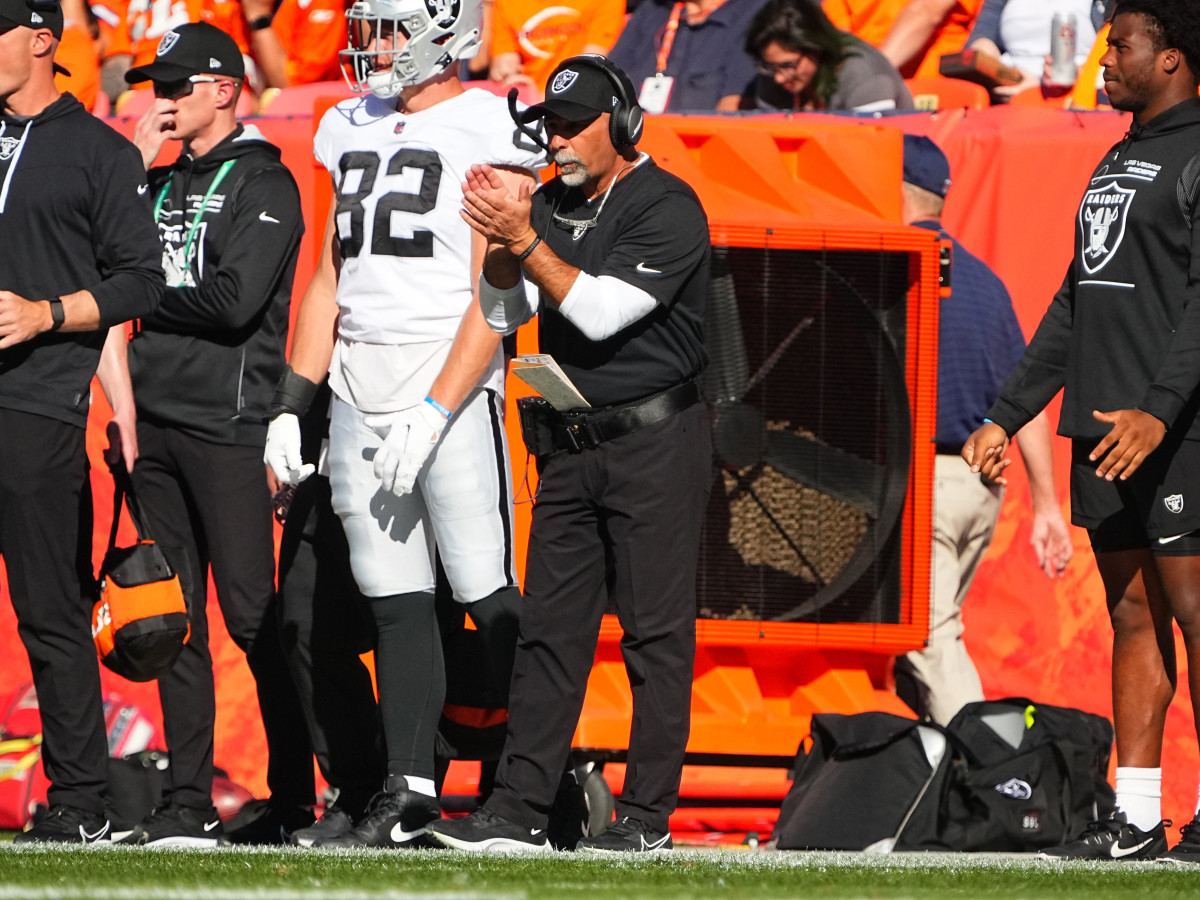 Las Vegas Raiders interim head coach Rich Bisaccia claps in the first half against the Denver Broncos at Empower Field at Mile High.