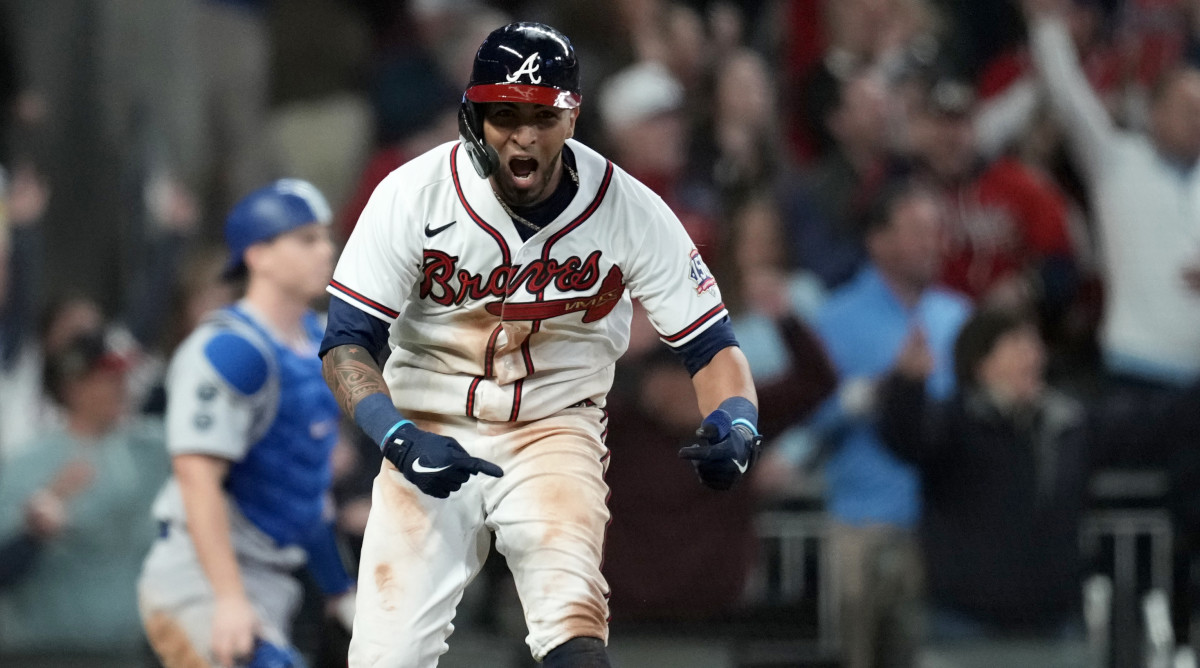 Oct 17, 2021; Cumberland, Georgia, USA; Atlanta Braves left fielder Eddie Rosario (8) celebrates his walk off game winning RBI against the Los Angeles Dodgers  during the ninth inning in game two of the 2021 NLCS at Truist Park.