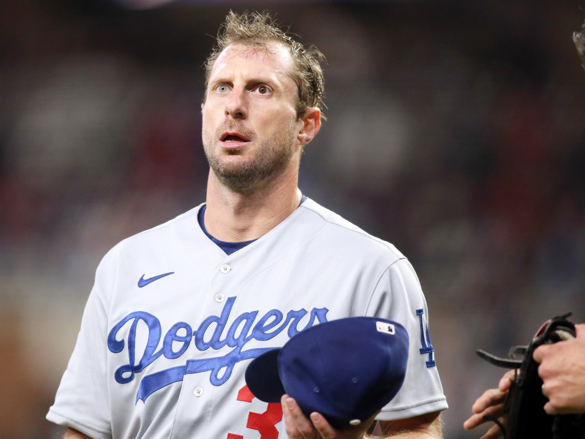 Oct 17, 2021; Cumberland, Georgia, USA; Los Angeles Dodgers starting pitcher Max Scherzer (31) has his glove and hat inspected between innings against the Atlanta Braves during the fourth inning in game two of the 2021 NLCS at Truist Park.