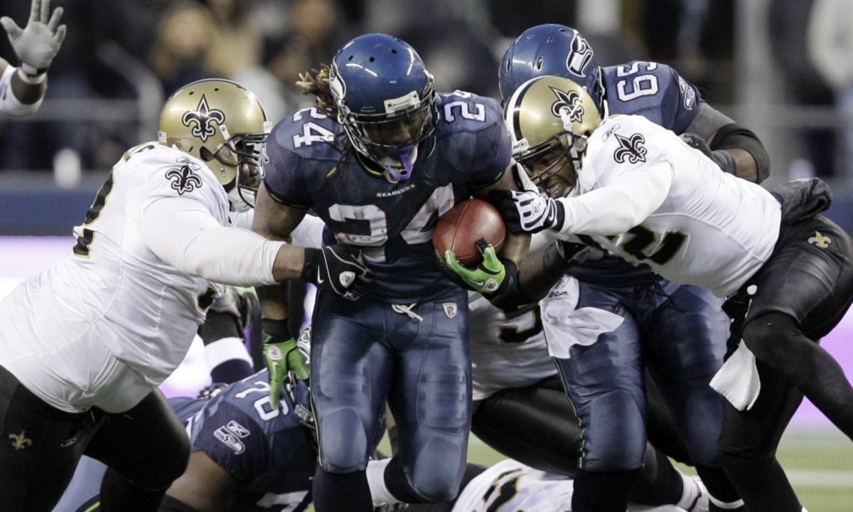 Seattle RB Marshawn Lynch breaks through the New Orleans defense for a game-clinching touchdown during a 2011 playoff game. Credit: USA TODAY 