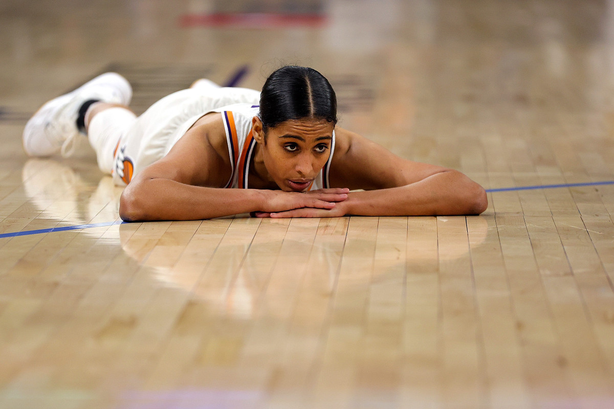 Skylar Diggins-Smith looking dejected laying on her stomach on the court