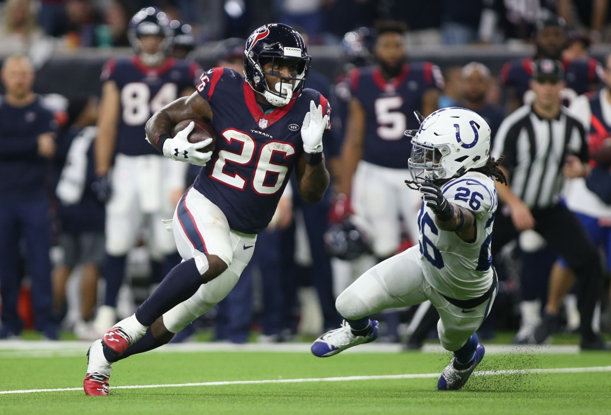 Houston Texans running back Lamar Miller (26) runs past Colts strong safety Clayton Geathers (26). Mandatory Credit: Troy Taormina-USA TODAY 