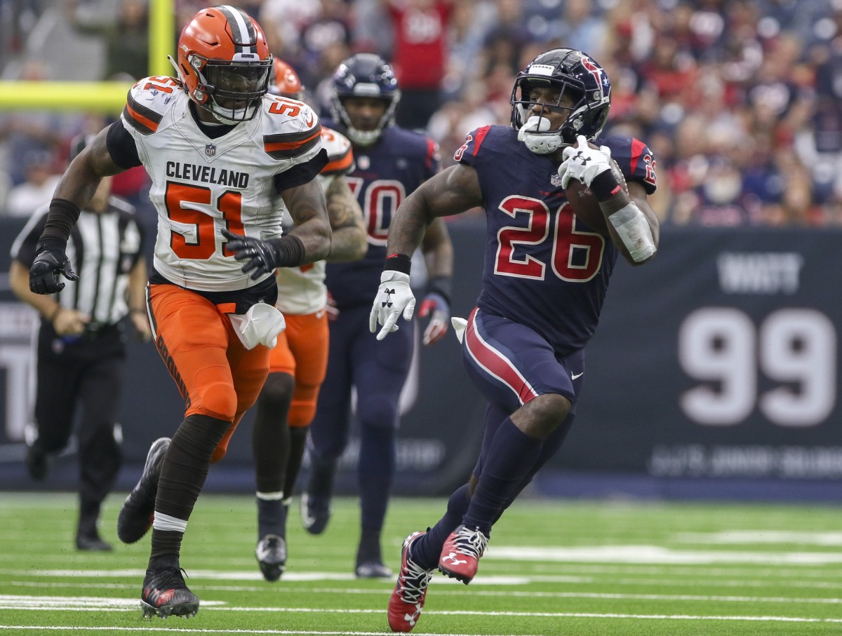 Houston Texans running back Lamar Miller (26) runs while being chased by Cleveland linebacker Jamie Collins (51). Mandatory Credit: John Glaser-USA TODAY Sports