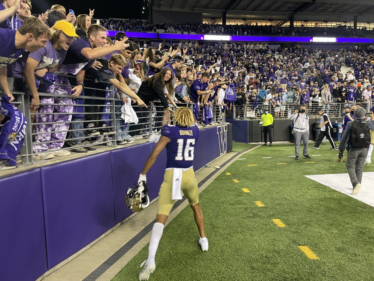 Rome Odunze celebrates a victory over Cal with Husky fans.