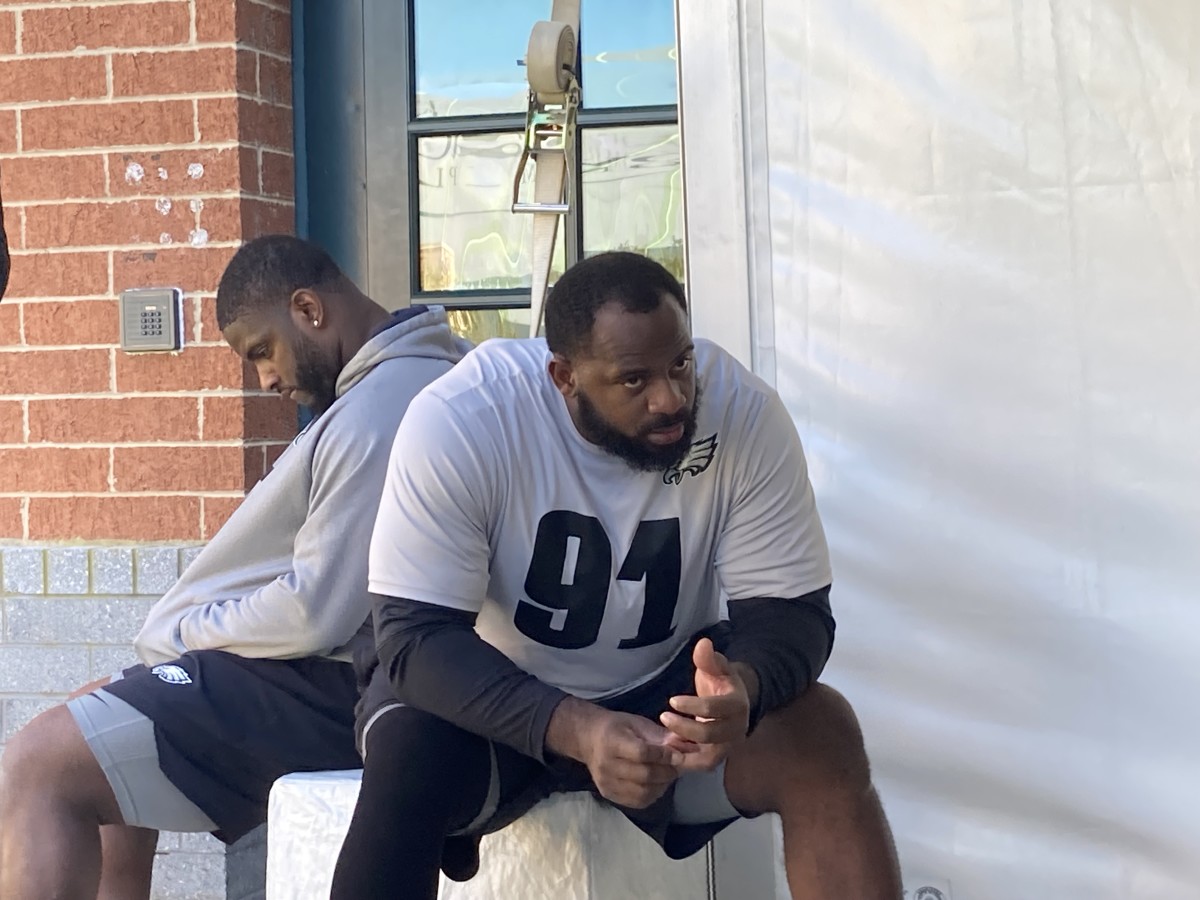 Eagles defensive takles Javon Hargrave (left( and Fletcher Cox wait their turns to speak to reporters on Wednesday, Oct. 20, 2021