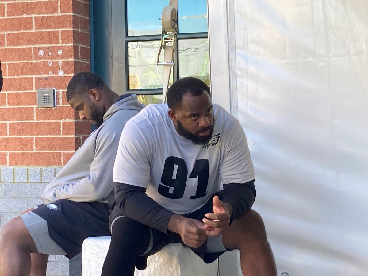 Eagles defensive takles Javon Hargrave (left( and Fletcher Cox wait their turns to speak to reporters on Wednesday, Oct. 20, 2021