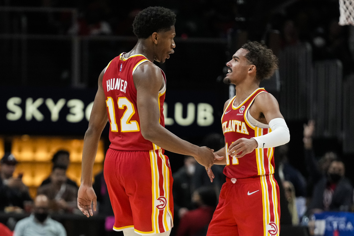 Atlanta Hawks forward De'Andre Hunter (12) shakes hands with guard Trae Young (11) after making a shot against the Dallas Mavericks during the second half at State Farm Arena.